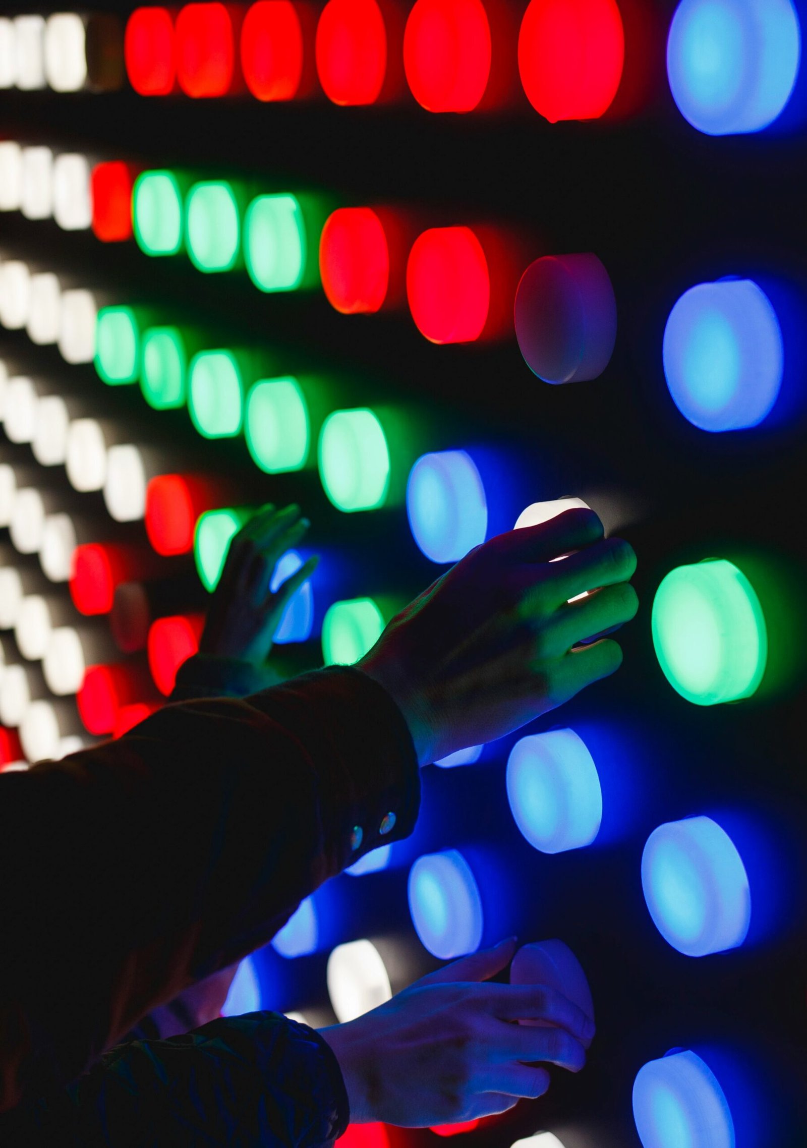 people holding assorted-color LED lights